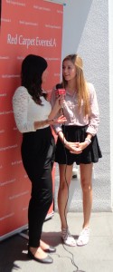 Alana Lee being interviewed on the red carpet at the Style Lounge Gifting Suite in honor of the Teen Choice Awards