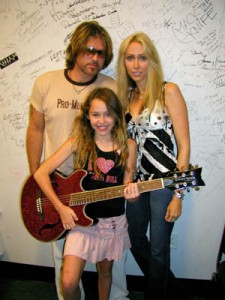 PHOTO CAPTION: Billy Ray Cyrus  and wife Tish presented their daughter Miley  with a Daisy Rock Girl Guitar  during Cyrus' press conference at the CMA Music Festival  in Nashville on June 13th.  The 12 year old aspiring guitarist and actress ( Big Fish , PAX TV's Doc)  becomes one of the youngest "tweener" spokesperson's to endorse the one and only girl guitar company. (Photo courtesy of Luck Media & Marketing, Inc.)