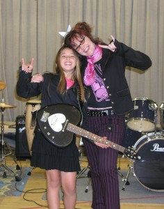 PHOTO CAPTION: (Pictured left to right) Raven Corletto-Juarez is presented with a black Daisy Rock Heartbreaker guitar as part of her two week Girls Rock Scholarship to DayJams Rock Music Day Camp  ( www.dayjams.com ) in Los Angeles, California.  Tish Ciravolo , President of Daisy Rock Girl Guitars ( www.daisyrock.com ), presented the guitar to Raven onstage at the culmination of the camp where campers performed for friends and relatives. Daisy Rock's ongoing mission is to provide females of all ages with whatever it takes to learn to play guitar and enjoy music.  Daisy Rock has established and continues to strengthen its reputation as " THE female guitar company."