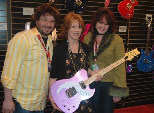 PHOTO CAPTION: Daisy Rock Girl Guitars' Ron Manus and Tish Ciravolo show Nancy Wilson (center), of the legendary rock band HEART  , the new Daisy Rock Tom Boy series guitar that was unveiled at the NAMM show in Anaheim. (Photo courtesy of Luck Media & Marketing, Inc.)