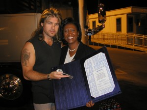 Councilwoman Lynette Boggs McDonald proclaims Billy Ray Cyrus an "Honorary Citizen of Las Vegas" and hands him the "key to the city."