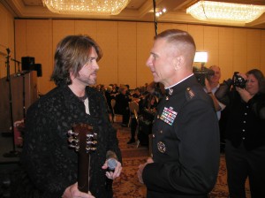 PICTURED LEFT TO RIGHT: 2003 Honorary Toys for Tots Spokesperson, Billy Ray Cyrus shares a few words with U.S. Marine Corps, Commandant General Michael W. Hagee. (Photo courtesy Luck Media & Marketing, Inc.)