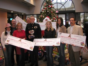PICTURED LEFT TO RIGHT : Country singer Sherrie Austin, Executive Director of CMA Ed Benson, Country singer Tammy Cochran, President Toys for Tots of Middle Tennessee Rob Kohls, Captain Thomas S. Little II, Santa Claus, Country singers Lila McCann and Memarie, and President Jeff Diamond of the Tennessee Titans.