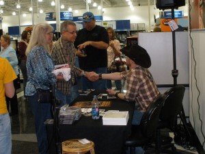 PHOTO CAPTION:  Minneapolis-based rising country star Shane Wyatt signing autographs for fans at the Best Buy in Maple Grove, MN