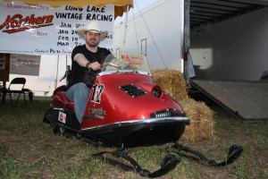 PHOTO CAPTION: Minneapolis Country music favorite Shane Wyatt checking out one of the snowmobiles at Outlaw Grass Drag in Princeton, MN on 8/22/2008